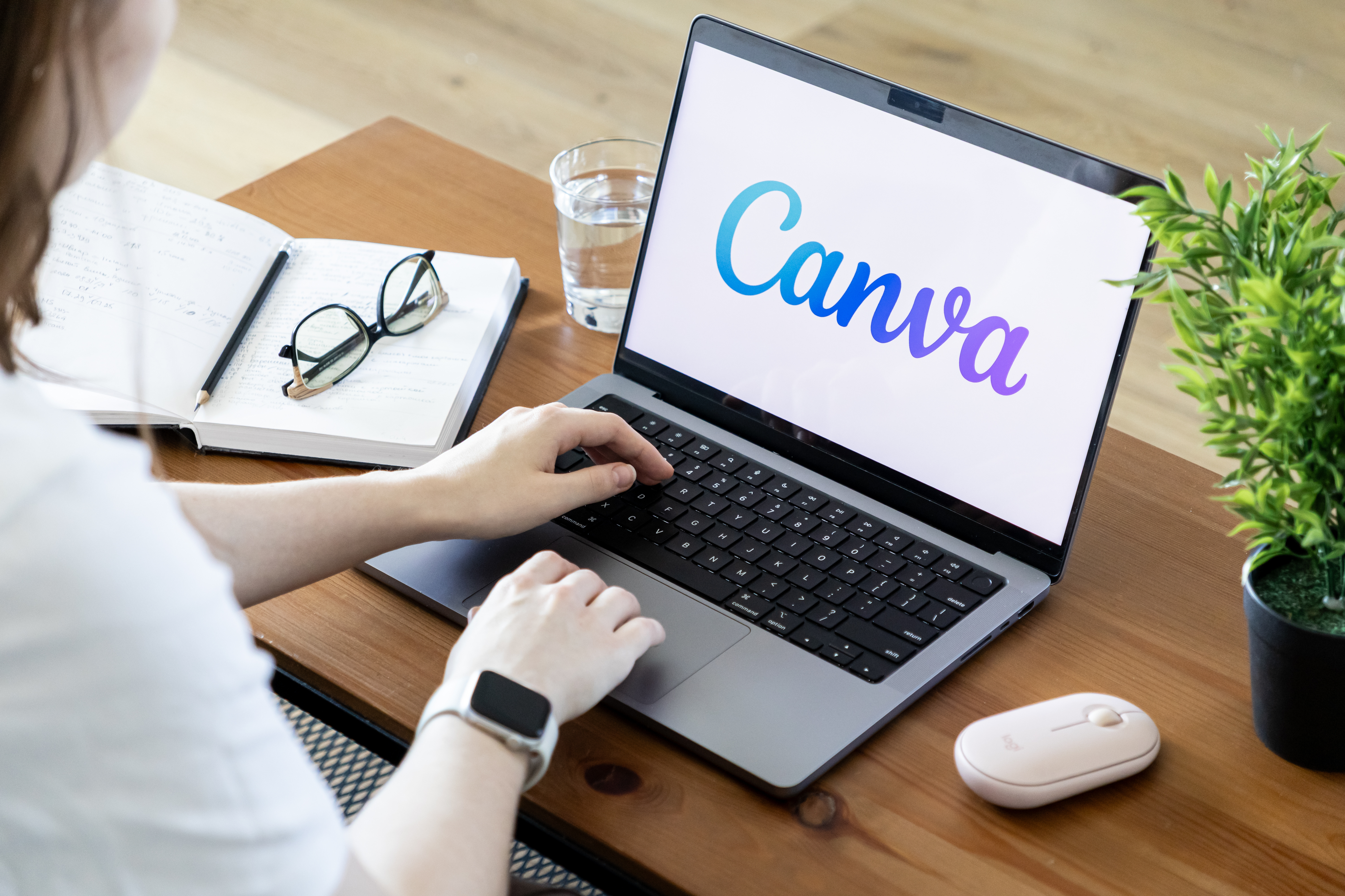 Poznan, Poland - June 15, 2025: Canva application showcased on a sleek laptop screen, illustrating a user engaged in digital design, promoting creativity and efficient remote work